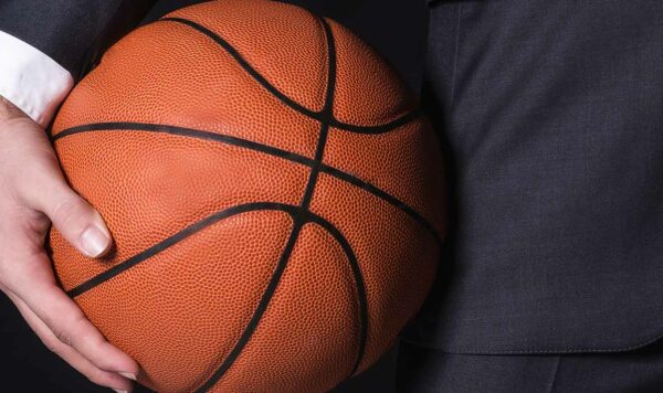 Business person holds a basketball